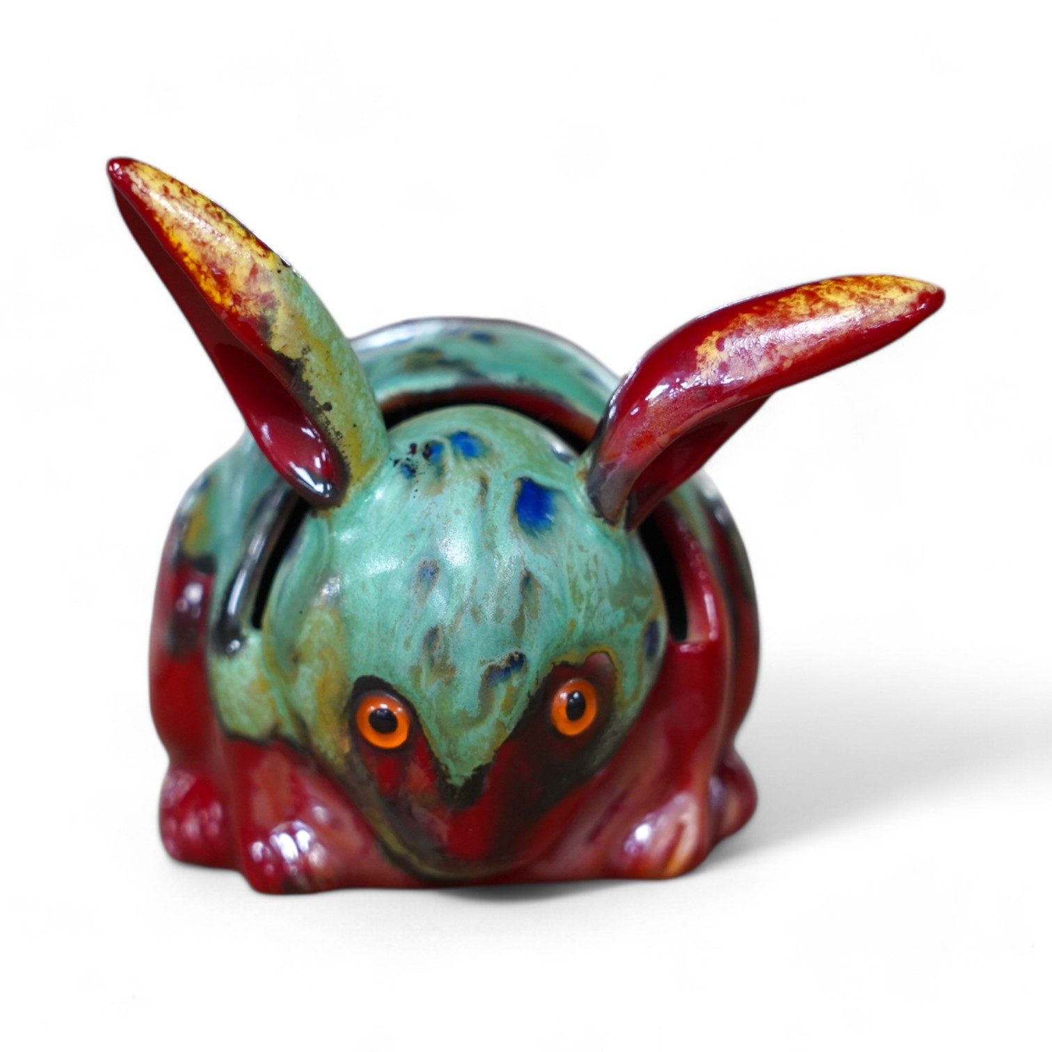 A Bernard Moore rabbit menu holder with inset orange glass eyes, c.1910, signed, 6cm high. Condition - good